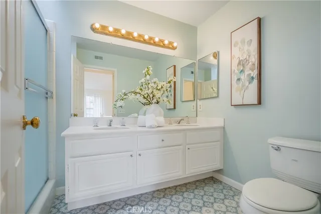 a front view of a house with a yard and potted plants