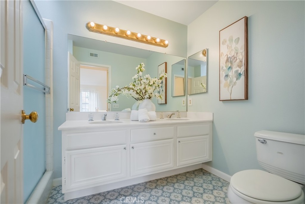 19 Dartmouth Irvine, CA 92612 - Photo 19 of 44 a bathroom with a sink a toilet and mirror