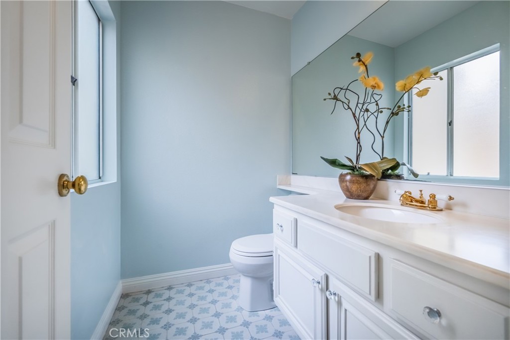 19 Dartmouth Irvine, CA 92612 - Photo 21 of 44 a bathroom with a granite countertop sink a toilet and a shower