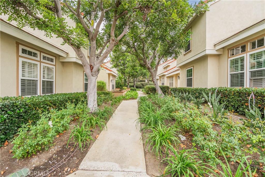 19 Dartmouth Irvine, CA 92612 - Photo 29 of 44 a front view of a house with a yard and potted plants