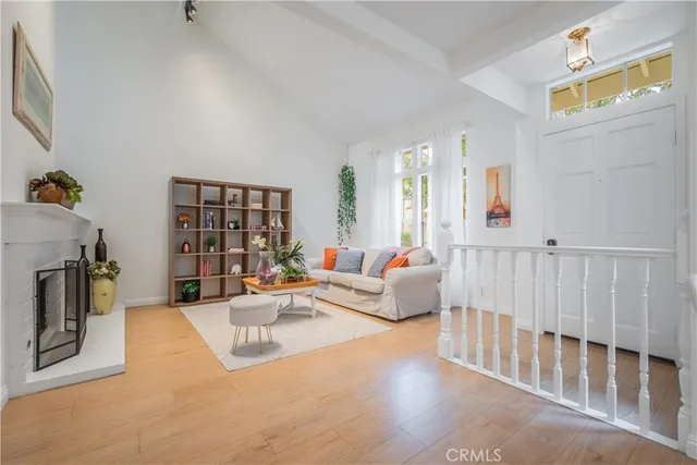 a dining room with furniture a chandelier and wooden floor