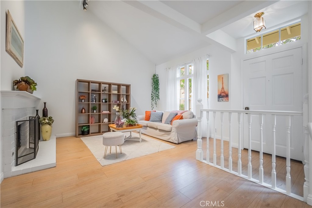19 Dartmouth Irvine, CA 92612 - Photo 4 of 44 a living room with fireplace furniture and a book shelf