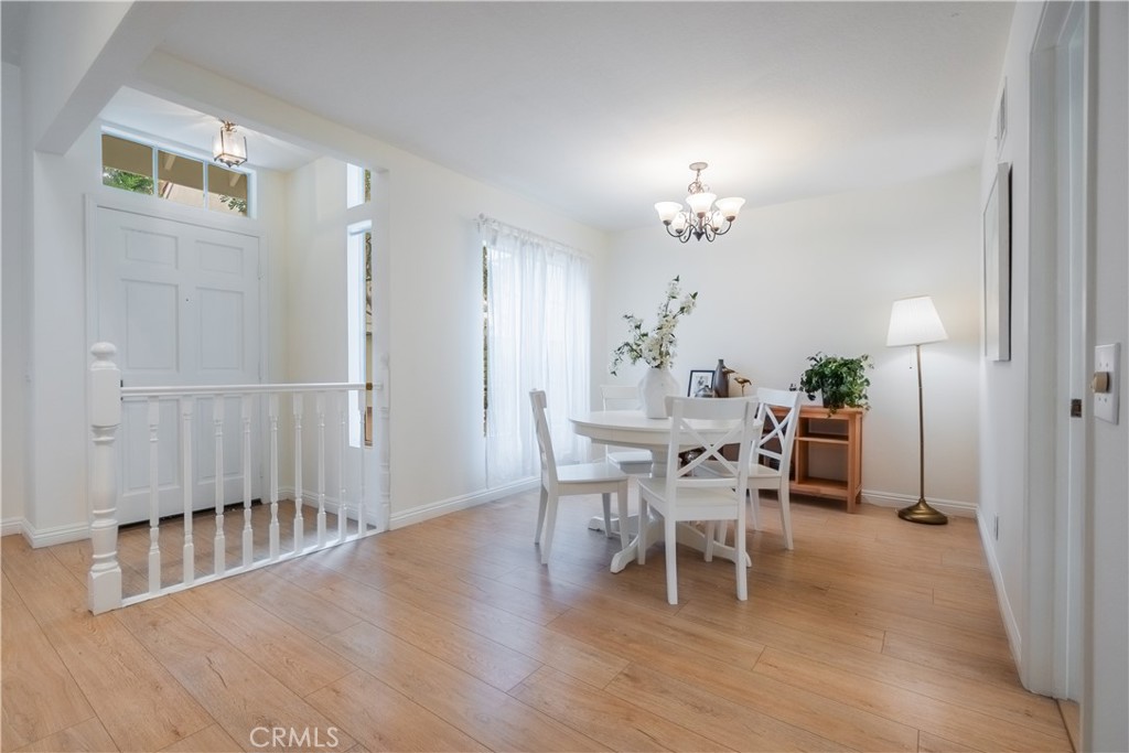 19 Dartmouth Irvine, CA 92612 - Photo 6 of 44 a dining room with furniture a chandelier and wooden floor