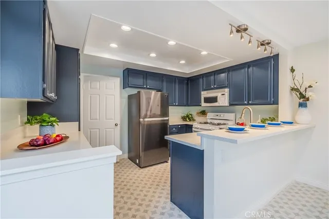 a kitchen with a sink stove and microwave