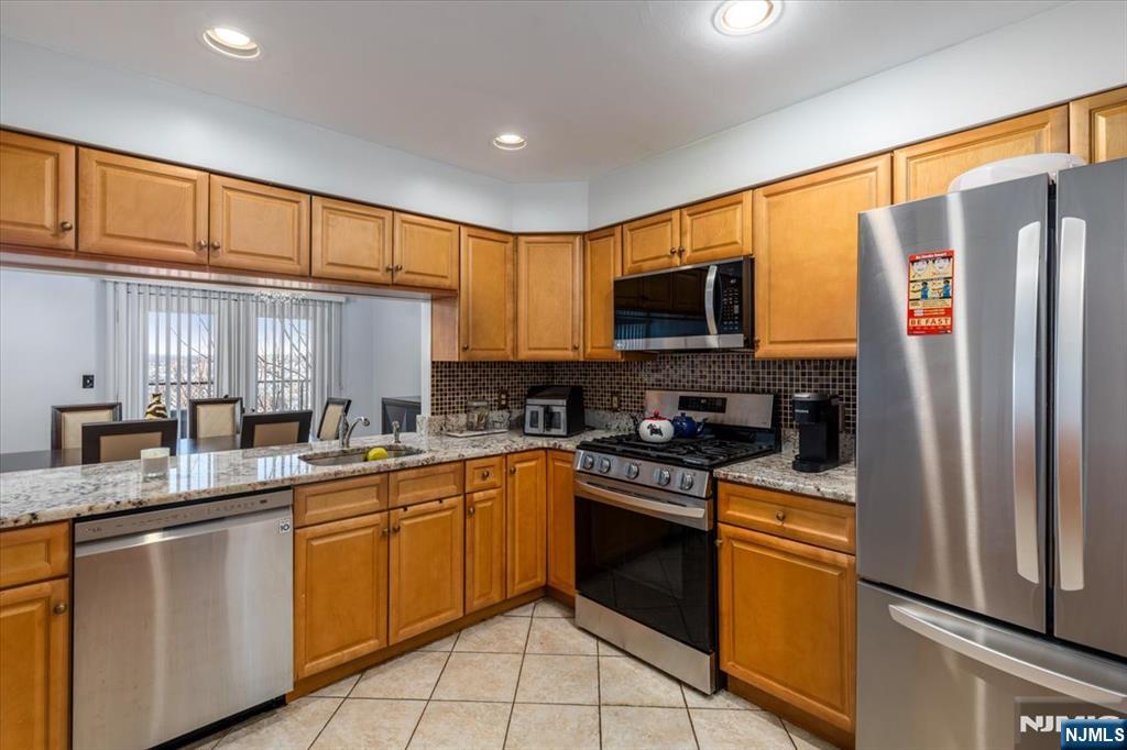 2 Crystal Lane, Unit 294 Paterson, NJ 07501 - Photo 1 of 30 a kitchen with stainless steel appliances granite countertop a refrigerator stove top oven a sink and dishwasher
