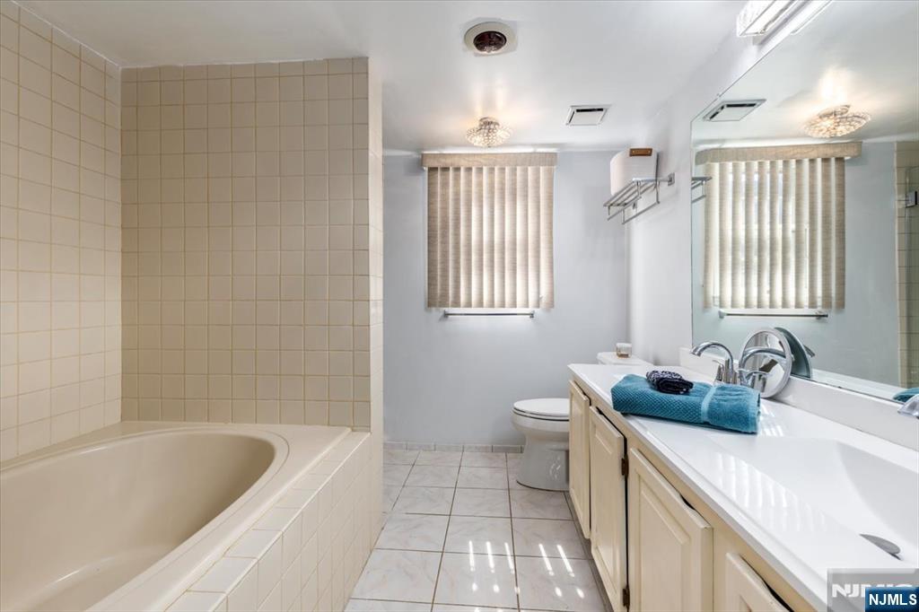 2 Crystal Lane, Unit 294 Paterson, NJ 07501 - Photo 14 of 30 a bathroom with a tub sink and a window