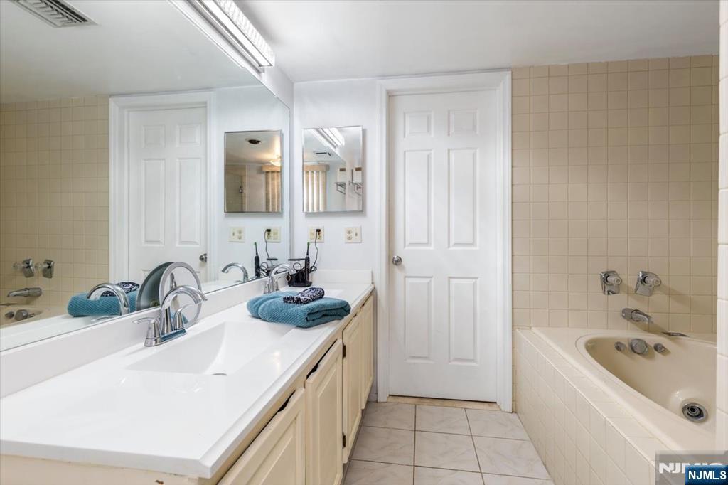 2 Crystal Lane, Unit 294 Paterson, NJ 07501 - Photo 15 of 30 a bathroom with a sink and a bathtub