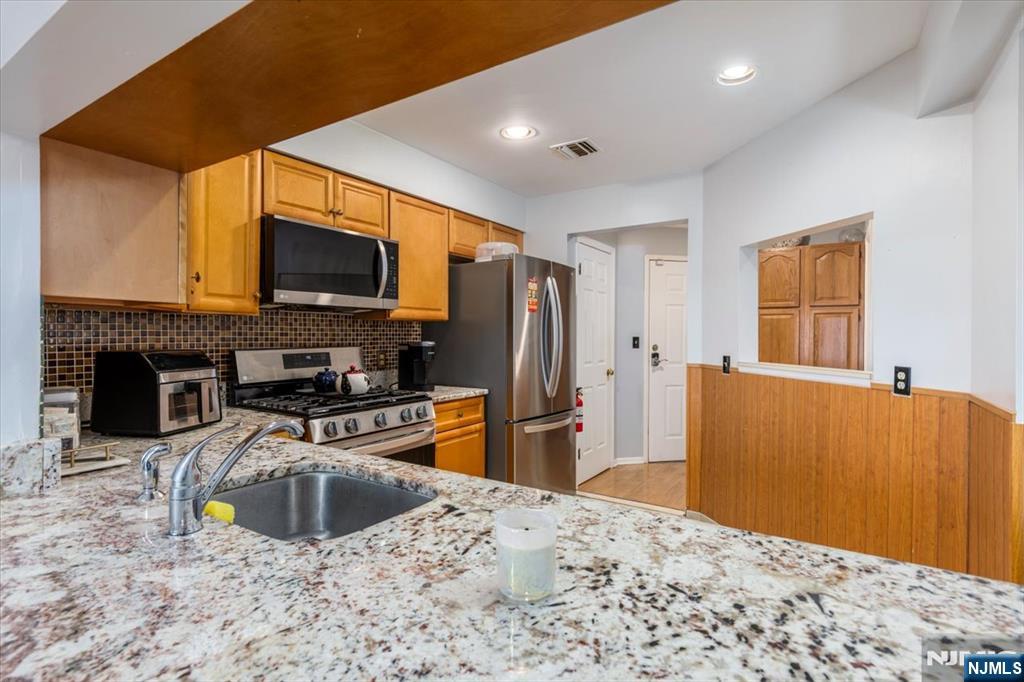 2 Crystal Lane, Unit 294 Paterson, NJ 07501 - Photo 3 of 30 a kitchen with a refrigerator a stove top oven a sink and dishwasher