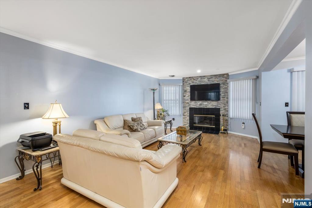 2 Crystal Lane, Unit 294 Paterson, NJ 07501 - Photo 4 of 30 a living room with furniture a fireplace and a flat screen tv