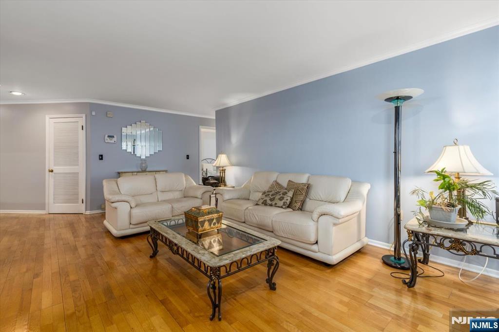 2 Crystal Lane, Unit 294 Paterson, NJ 07501 - Photo 6 of 30 a living room with furniture and a potted plant on table