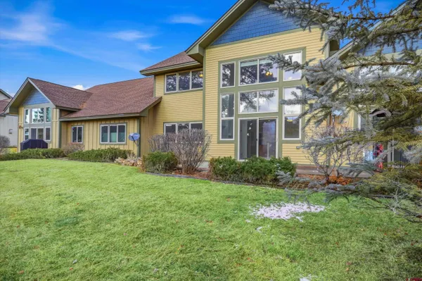 a front view of a house with a yard and trees