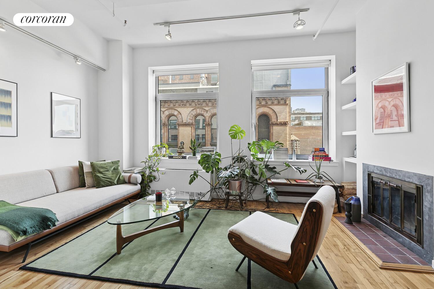 a living room with furniture and a fireplace