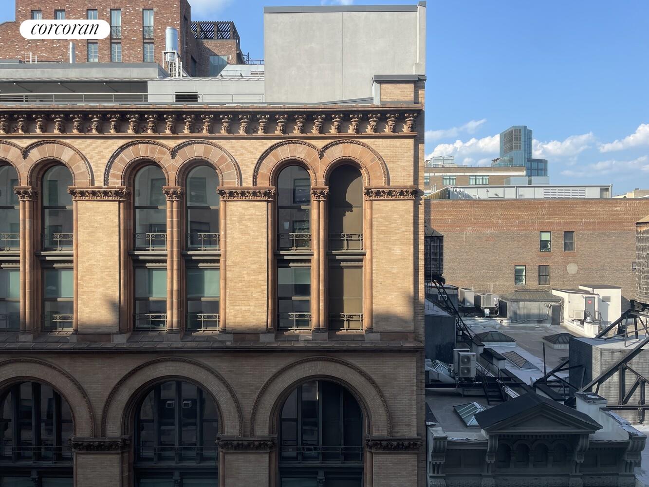 14 East 4th Street, Unit 827 Manhattan, NY 10012 - Photo 8 of 10 a view of a kitchen with stainless steel appliances granite countertop a stove and a kitchen island with a dishwasher