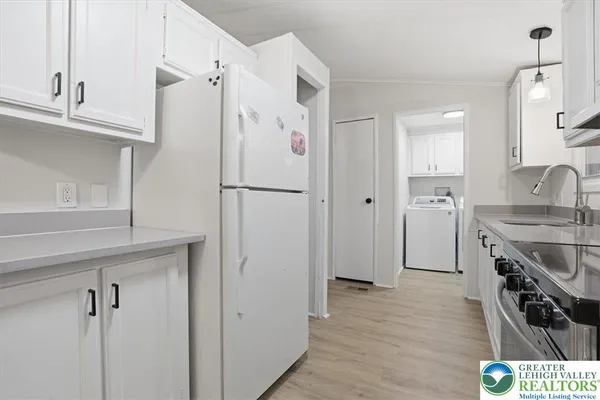 a kitchen with stainless steel appliances a refrigerator and cabinets