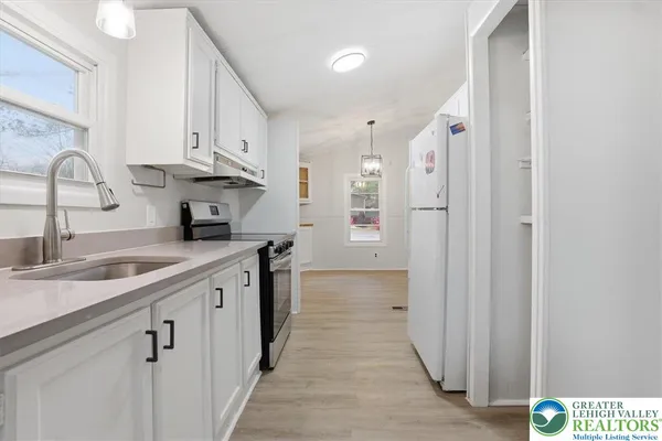 a kitchen with cabinets and a sink