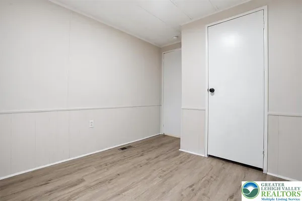 a view of a room with wooden floor