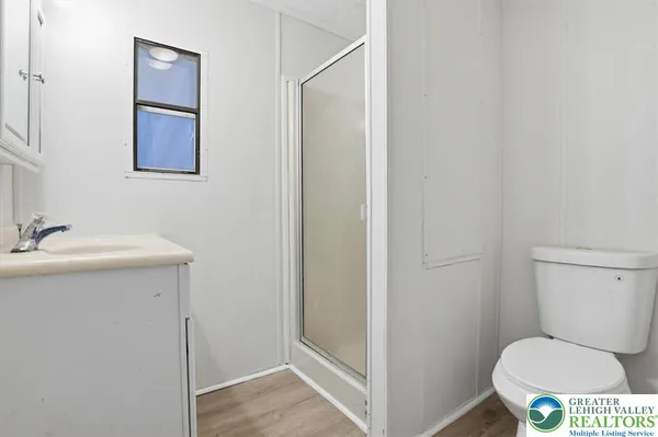 a bathroom with a toilet sink and a mirror