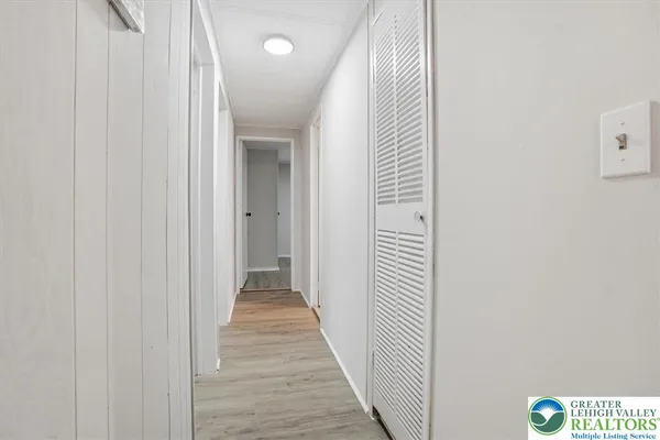 a view of a hallway with wooden floor