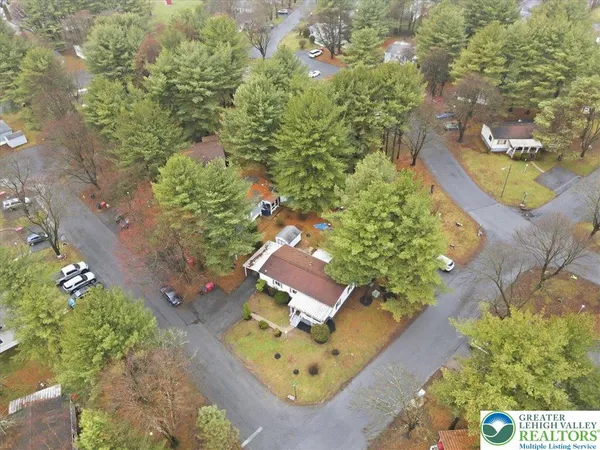 an aerial view of a house with a yard and lake view