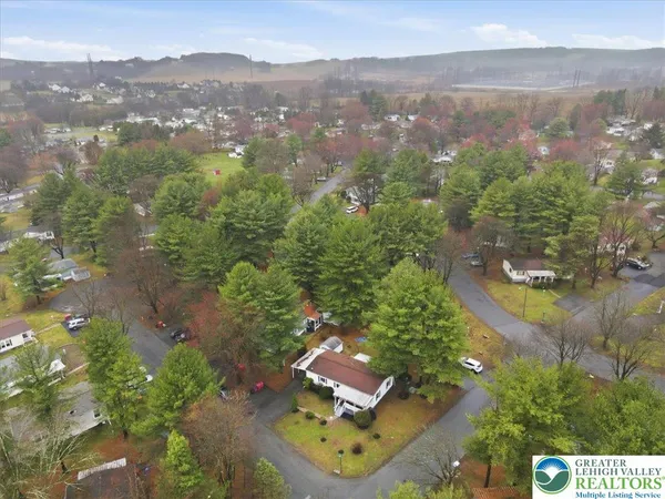an aerial view of residential houses with outdoor space and swimming pool