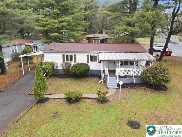 aerial view of a house with swimming pool and porch