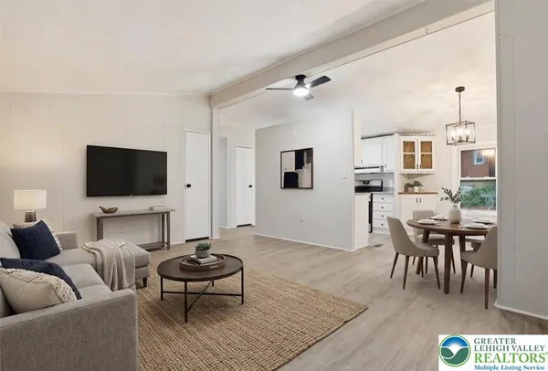 a living room with furniture a rug and a flat screen tv