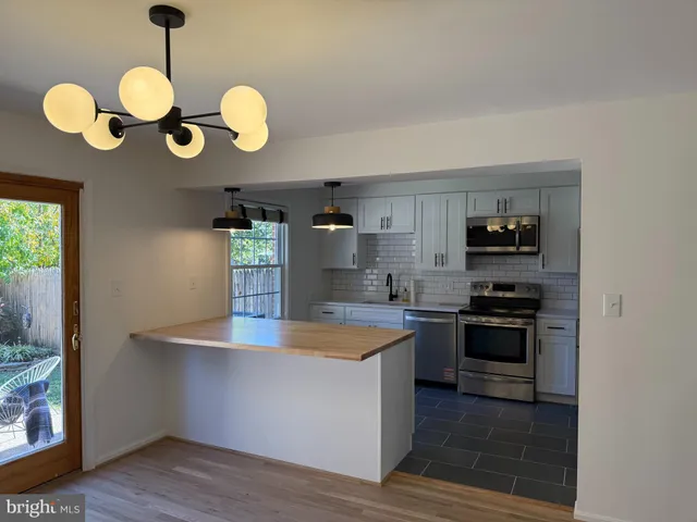 a kitchen with cabinets and stainless steel appliances