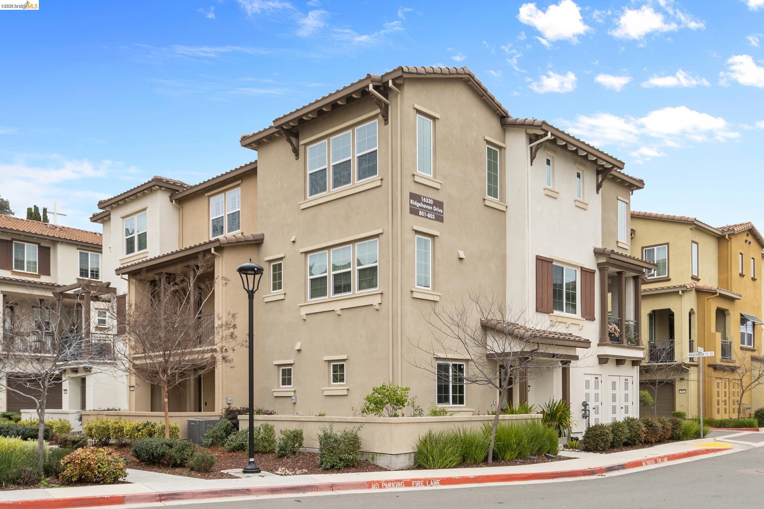 16330 Ridgehaven Drive, Unit 802 Castro Valley, CA 94578 - Photo 1 of 1 a front view of a residential apartment building with a yard