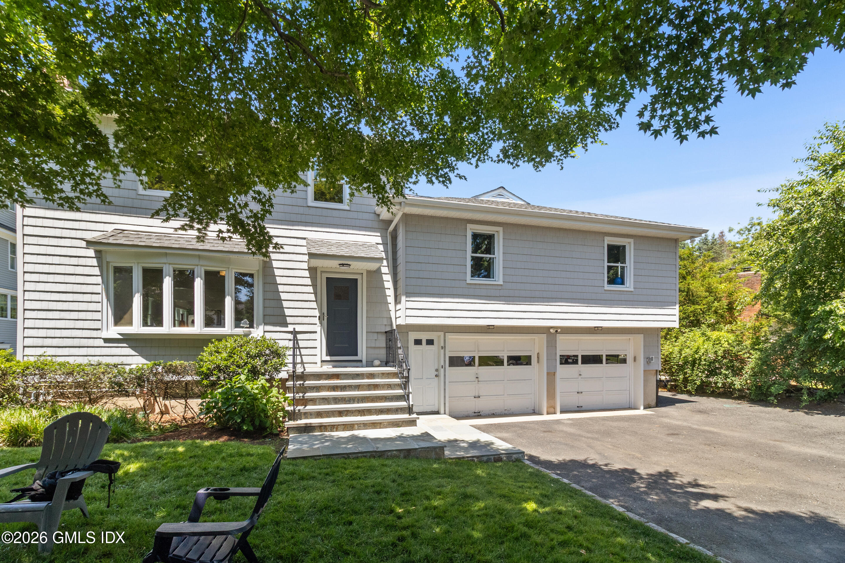 9 Deluca Drive Cos Cob, CT 06807 - Photo 1 of 30 a front view of a house with a yard and garage