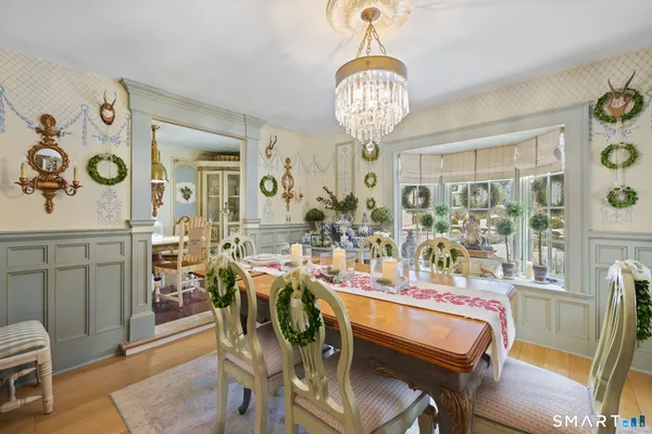 a view of a dining room with furniture and chandelier