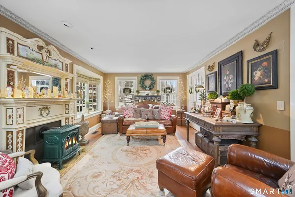 a living room with furniture large window and wooden floor