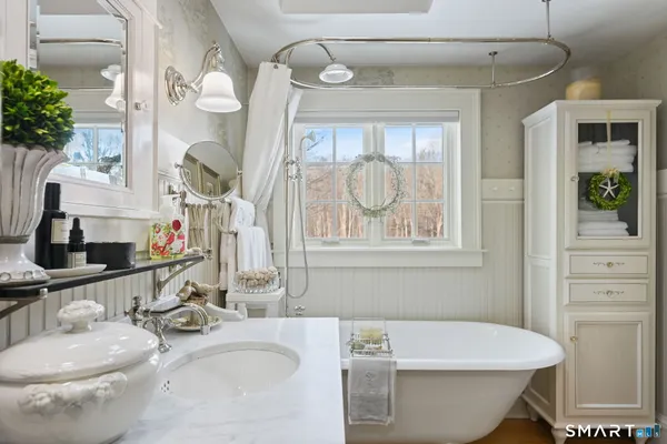 a bathroom with a sink and mirror with toilet