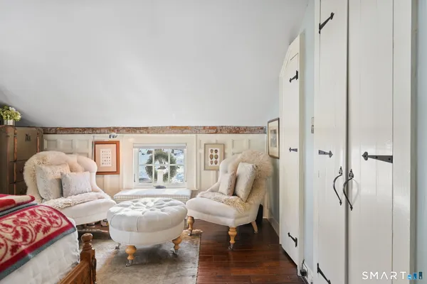a view of a bedroom with furniture and wooden floor