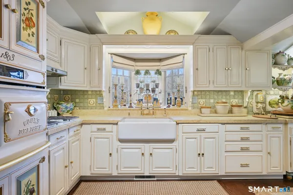 a kitchen with granite countertop a sink and cabinets