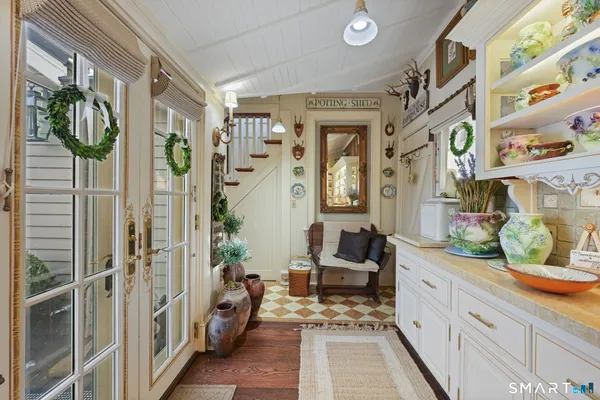 a hallway with a couch and chandelier