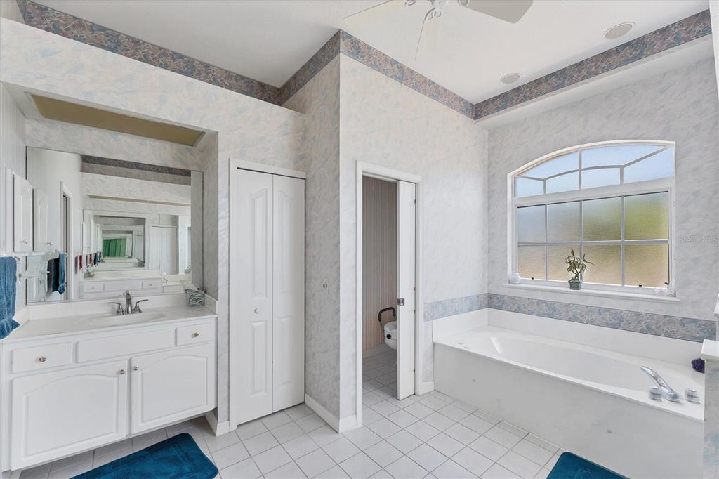 285 Spaniards Road Placida, FL 33946 - Photo 21 of 61 a bathroom with a tub sink and mirror