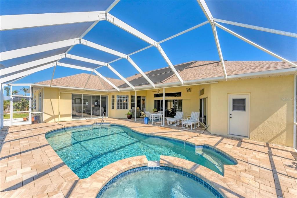 285 Spaniards Road Placida, FL 33946 - Photo 23 of 61 a view of a backyard with table and chairs under an umbrella