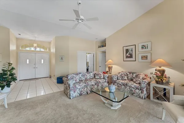 a living room with furniture and a night stand