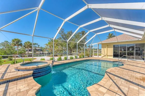 a view of a house with swimming pool and sitting area