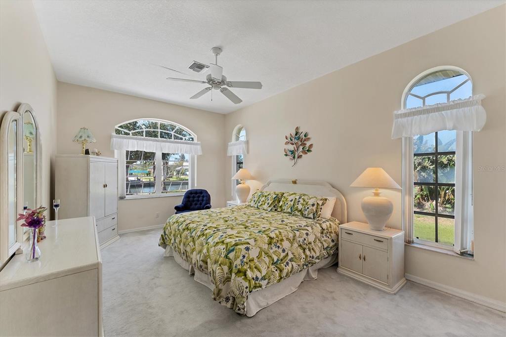 285 Spaniards Road Placida, FL 33946 - Photo 40 of 61 a bedroom with a bed and a chandelier