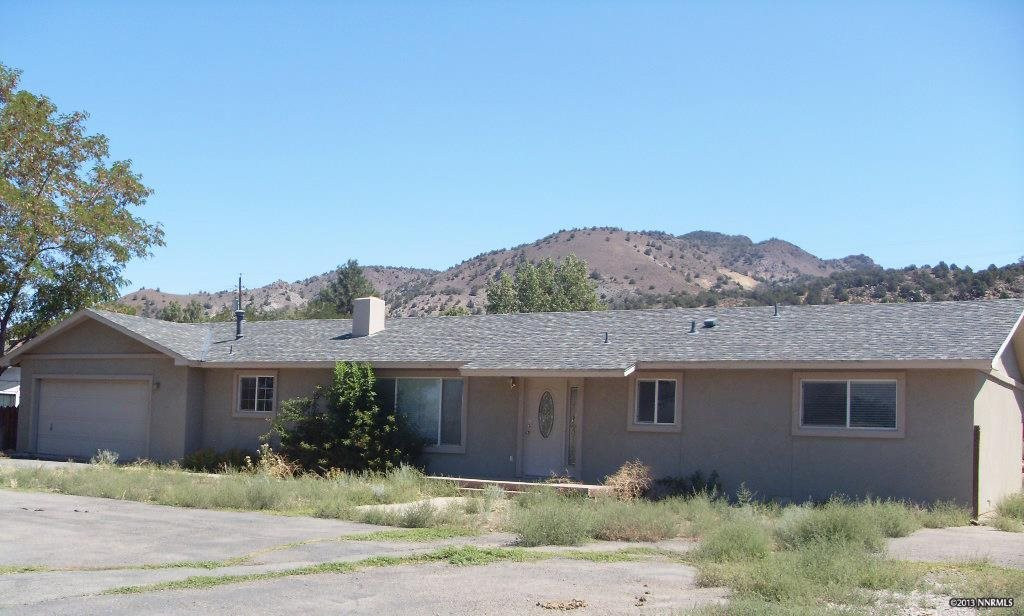 14660 Chamy Drive, Unit 1 Reno, NV 89521 - Photo 1 of 1 a view of a house with a yard and a large tree