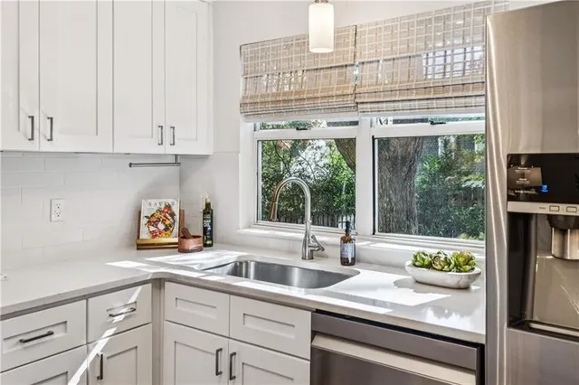 a kitchen with appliances cabinets and a sink