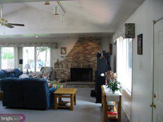 9 Hawthorne Road Kendall Park, NJ 08824 - Photo 3 of 5 a living room with furniture and a fireplace