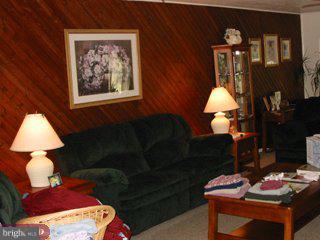 9 Hawthorne Road Kendall Park, NJ 08824 - Photo 4 of 5 a living room with furniture and a lamp