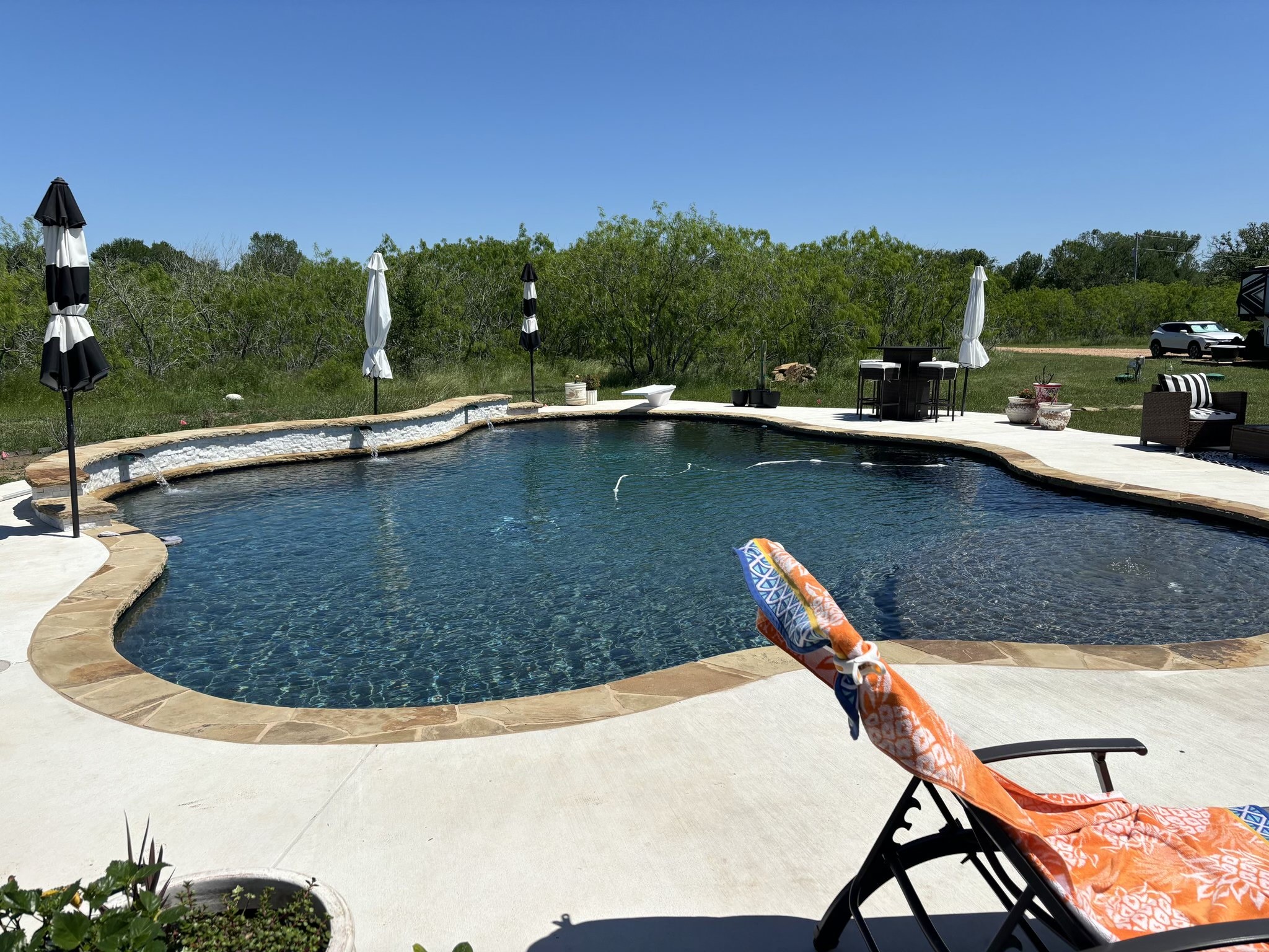 6289 Maynard Hallmark Road Flatonia, TX 78941 - Photo 6 of 19 a view of a swimming pool with a chair and a floor to ceiling window