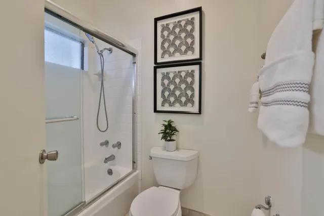 a bathroom with a toilet sink and shower