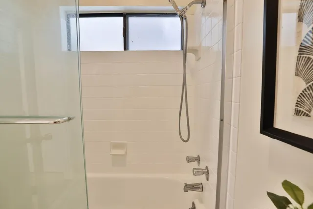 a bathroom with a glass shower door