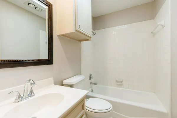 a bathroom with a sink a toilet and bathtub