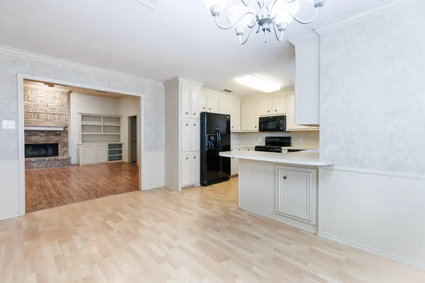 a view of a kitchen with microwave and cabinets