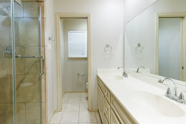 a bathroom with a tub sink and mirror